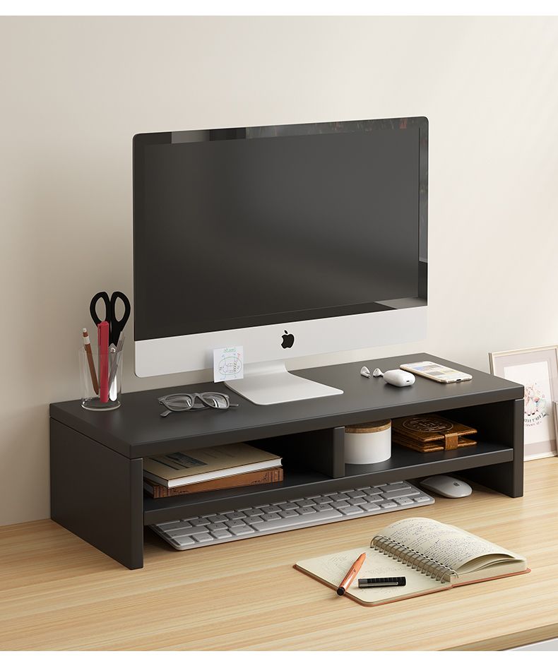 Black wooden monitor stand riser with storage shelves on a light wood desk