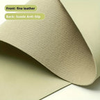 Close-up of a sage green desk mat showing fine leather front and suede anti-slip back.