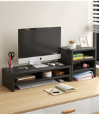 Black wooden desk organizer with monitor stand and storage shelves on a light wood desk